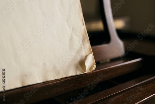 Macro close up of a sheet music book on a piano stand with a dog-eared corner