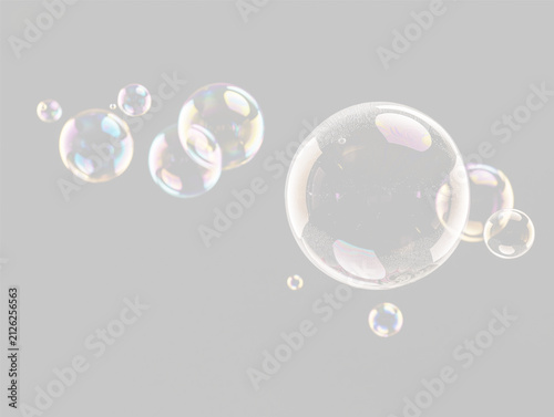 Cluster of translucent soap bubbles with colorful reflections against a black background on transparent background