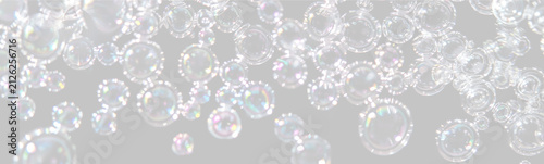 Close-up of shimmering soap bubbles with colorful reflections against a black background on transparent background