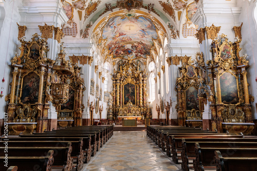 Fotografie Symmetrical interior view of church Mariä Himmelfahrt with golden baroque altar,
