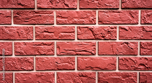 Red painted brick wall texture background with rough masonry pattern. Architectural surface for construction, design, wallpaper or backdrop with copy space.