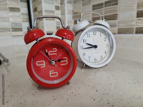Photography Two retro alarm clocks standing side by side symbolizing time management, urgenc