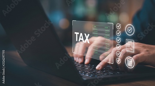 Close up of person hands typing on laptop keyboard with virtual tax interface and digital icons for tax calculation and financial reporting
