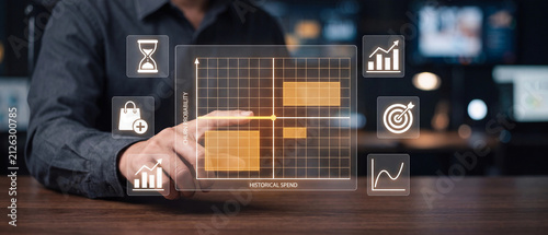 Businessman analyzing customer churn probability and historical spend data on a digital holographic interface