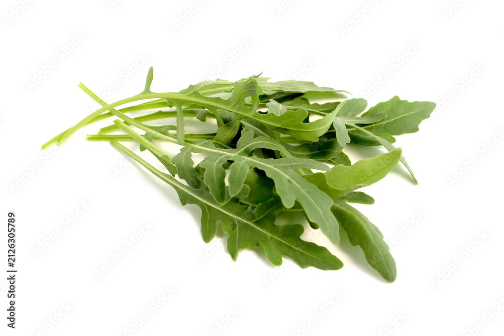 Fototapeta premium Arugula leaves lie on a white background.