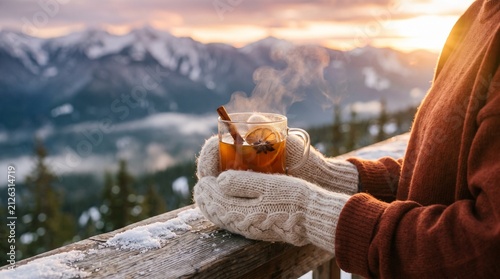 Warm Spiced Apple Cider in Glass Mug Overlooking Snowy Mountain Sunset