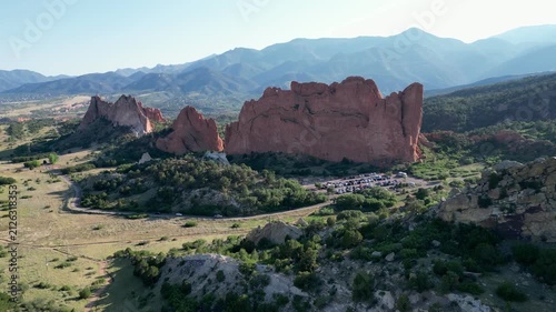 Distant aerial flyover of Colorado park with mountains in the background