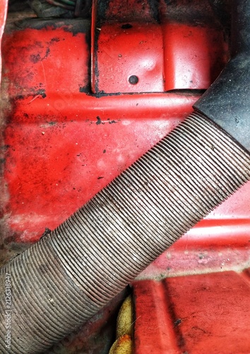 Foto close up detail of a mechanical automotive engine with red color