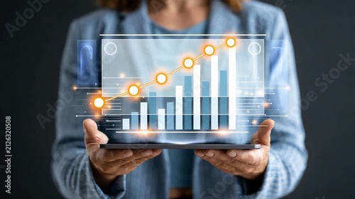 Business Growth Visualization: A person holds a tablet displaying a holographic chart showcasing upward trending business growth, with glowing indicators and a futuristic interface.