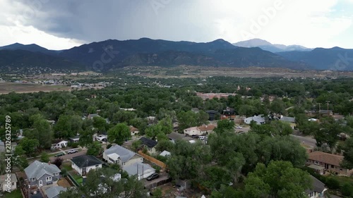 Drone flyover of cloudy day with mountains in background