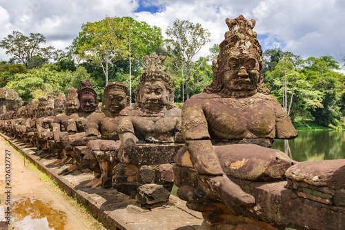 Ancient stone guardian statues lining the causeway at the South Gate of Angkor Thom in Siem Reap, Cambodia