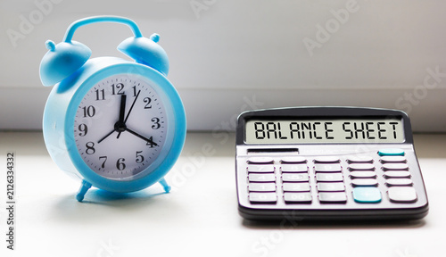 The text of the balance sheet and financial statements is displayed on the calculator.