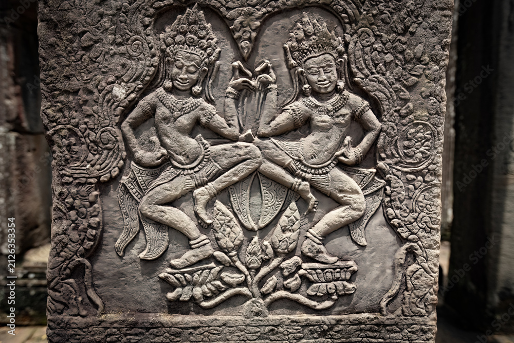 Fototapeta premium Ancient sandstone bas-relief depicting a historical battle and warriors on the walls of Bayon Temple in Angkor Thom, Siem Reap, Cambodia
