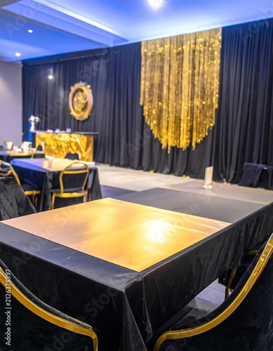 Elegant Banquet Hall Setup with Black and Gold Decor.