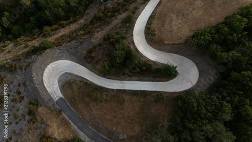 Bild auf Leinwand Aerial view of a winding mountain road