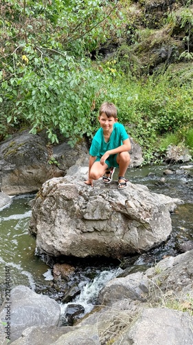 Fotografie 10-year-old boy exploring rocky landscape in Divoka Sarka nature reserve in Prag