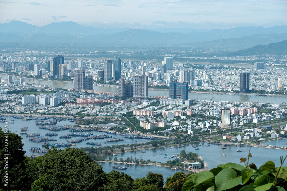 Fototapeta premium Panoramic photograph of Da Nang city skyline and coastline viewed from the back ridge of Son Tra peninsula with copy space