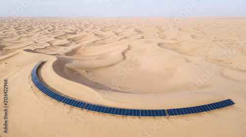 Solar panels on desert dune landscape view creating peaceful sustainable energy scene with hopeful environmental future