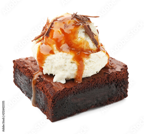 Foto Tasty brownie with ice cream and caramel topping isolated on white