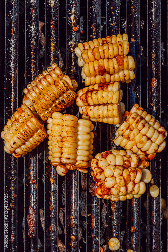 Grilled corn on the cob pieces roasting on a barbecue