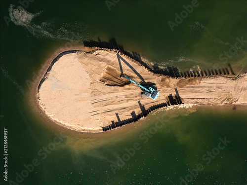Fotografie Aerial view of an excavator working on the sandy shore of Lampedziai Beach in Kaunas, Kauno apskritis, Lithuania