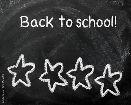 Back to School Text and Drawn Chalk Stars on Blackboard