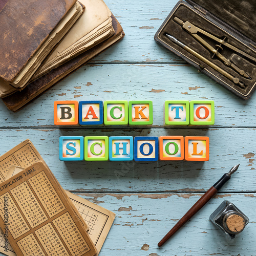 Back to School Wooden Blocks Concept on Vintage Blue Wooden Desk