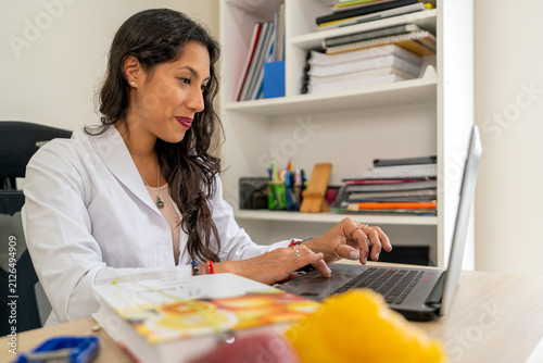 Female nutritionist consulting online in professional office