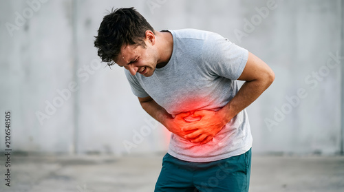 Man clutching his abdomen in physical pain