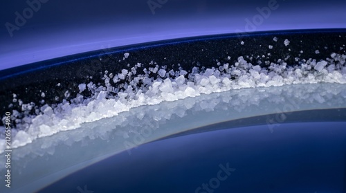 Macro Texture of Epsom Salt Crystals on Float Tank Edge, Close Up High Salinity Water Line, Indigo LED Backlight, Wellness Spa Detail, Abstract Commercial Photo
