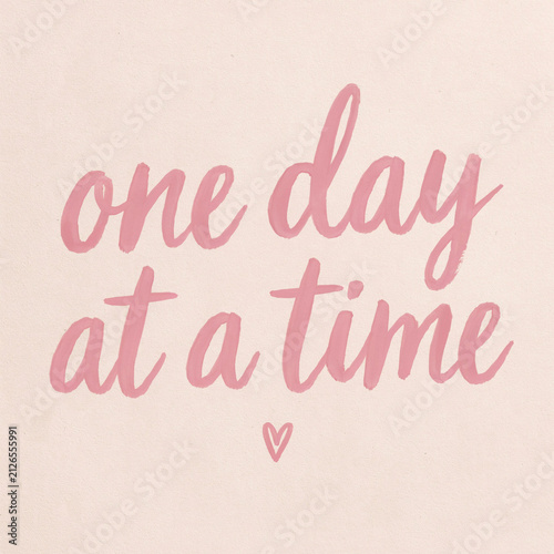 Inspirational brush stroke lettering in vibrant pink displaying the motivational phrase one day at a time accompanied by a delicate heart symbol painted with a textured artistic style