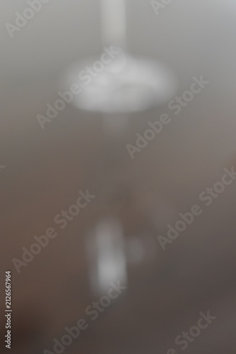 Cuadro en lienzo A dreamy view of a simple lamp hanging on a wall.