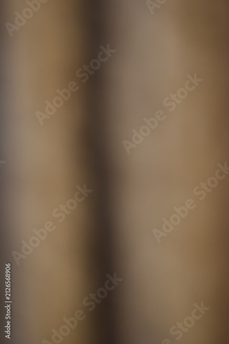 Fotografie A dreamy view of a beige curtain hanging on the wall.