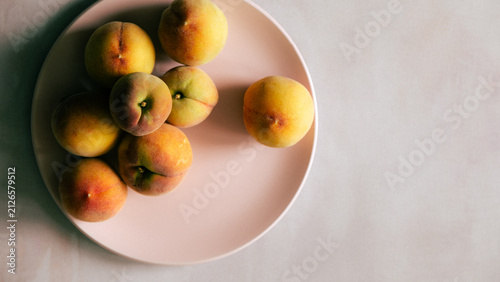 Fresh peaches on pink plate with soft background
