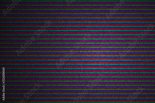 Macro close up view of an electronic LED screen display showing red green and blue subpixel light emitting diodes 