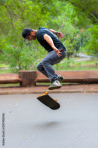 Skateboarder performing an aerial trick in a city park