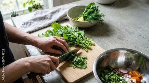 Fresh Greens Being Chopped For A Healthy Salad Preparation