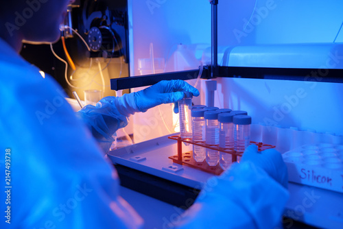 Bild auf Leinwand Laboratory technician conducting tests with test tubes in a chemistry lab enviro