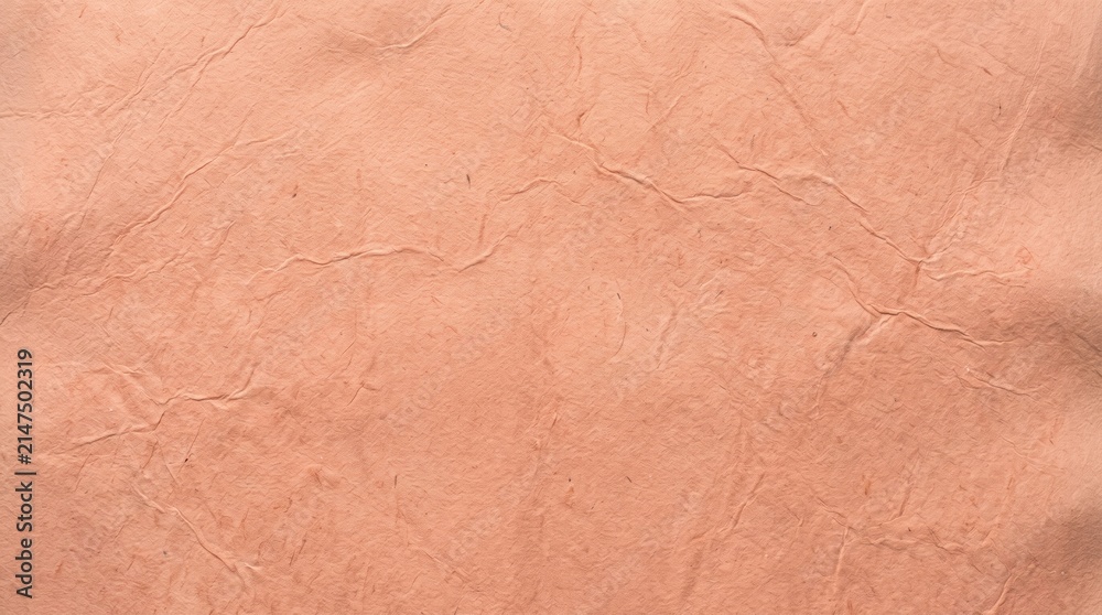 Fototapeta premium A high resolution close up view of a soft light peach colored paper texture background design