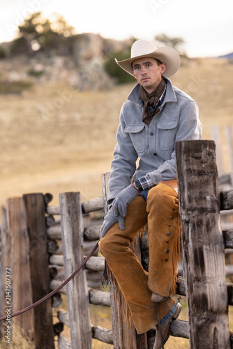 Wyoming Cowboy sitting on fence Ranch scenic