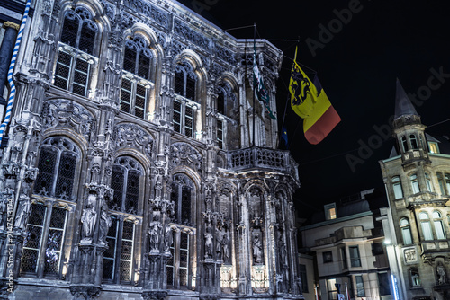 Highly Detailed Historic Stone Facade and Flag Illuminated at Night in Ghent, Belgium