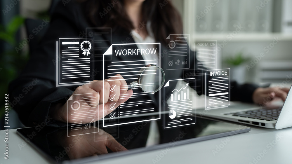 Obraz premium Professional Businesswoman Analyzing Workflow and Invoice Documents with Magnifying Glass in Modern Office Environment. Bitwise.