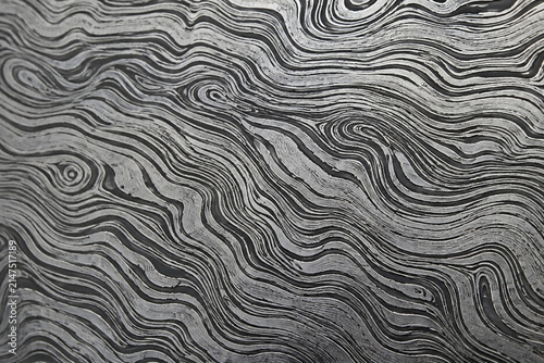 abstract monochrome wavy pattern background mimicking damascus steel and wood grain texture