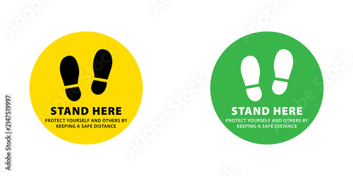 Stand here social distancing floor sticker signs with footprints in yellow and green circular shapes