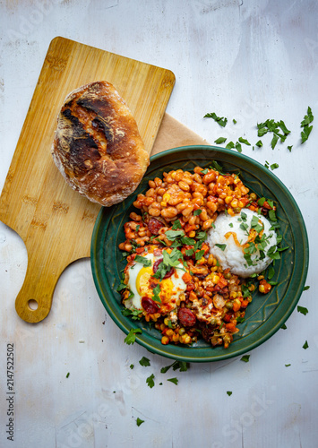 Cuadro en lienzo Mexican-style bowl with black beans, spicy chorizo sausage, roasted vegetables, fresh herbs, and rice
