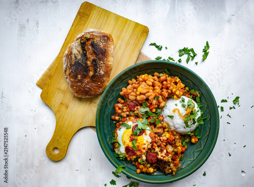 Photography Mexican-style bowl with beans, spicy chorizo sausage, roasted vegetables, fresh herbs, and rice