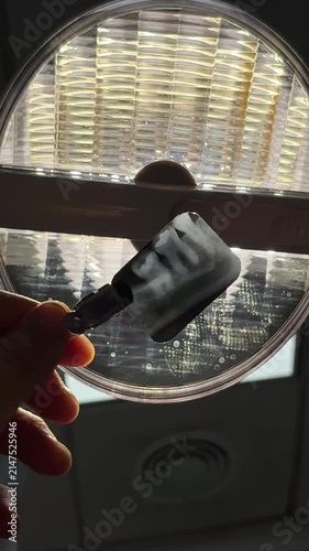 Dental X-ray film held against a viewing light during a dental examination in a modern clinic. Real oral diagnostic imaging showing molars, dental restoration and clinical equipment. Concepts of denti