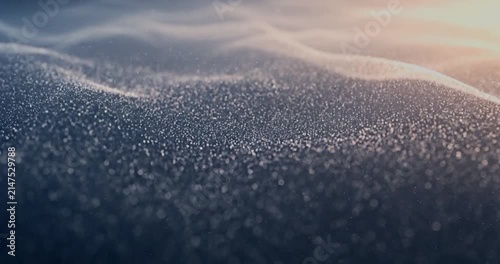 Abstract dark blue fluid waves with sparkling particles.