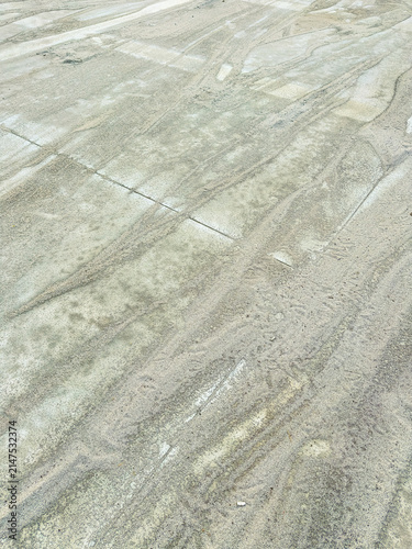 Bild auf Leinwand Ground covered with sand showing patterns from movement, taken during daylight i