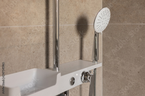 Close-up of premium modern shower head and mixer tap in luxury bathroom